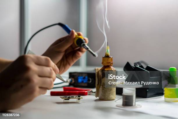 Soldering Iron With Smoke From Boiling Rosin Or Colophony B Stock Photo - Download Image Now