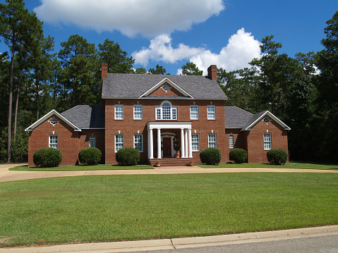 Thomasville, Georgia, USA - September 25, 2009:  Large two story red brick residential home with side entry garage.
