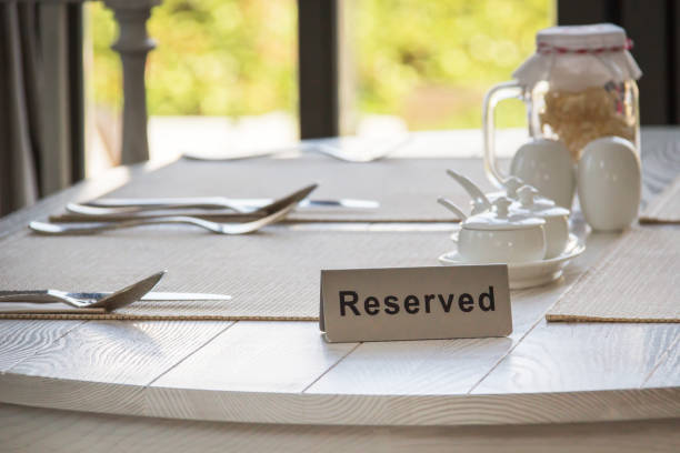 istock Reserved sign on a table in restaurant by the window. 1128389543