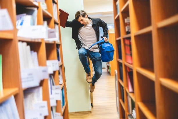 istock happy student jumping with books and backpack b 1128391483