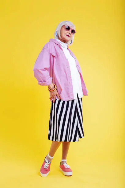 Photo of Stylish retired lady wearing striped white and black skirt
