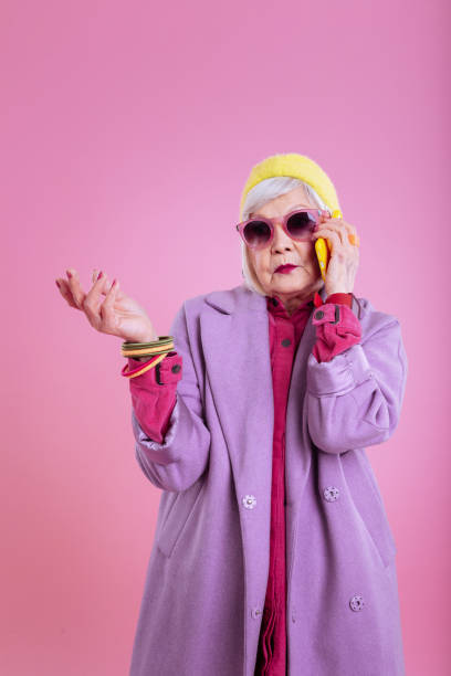 istock Cute stylish elderly lady wearing purple coat feeling concerned 1128391645
