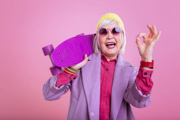Modern retired woman wearing red smart watch feeling positive