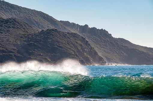a wave breaks when arriving on the Corsican coast