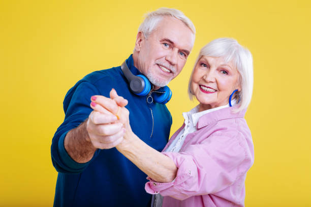 istock Retired woman with pink lips and nails dancing with husband 1128393166