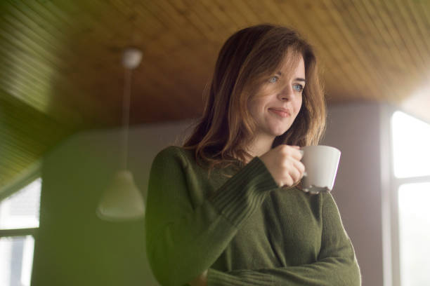 istock Young woman drinking tea 1128394117