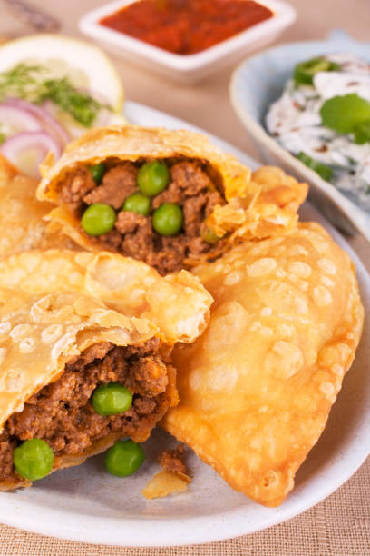 Samosas with Meat Appetiser or Party Food. Indian Cuisine Crisp Indian samosas stuffed with spicy lamb keema and peas. Perfect party food. appetiser stock pictures, royalty-free photos & images