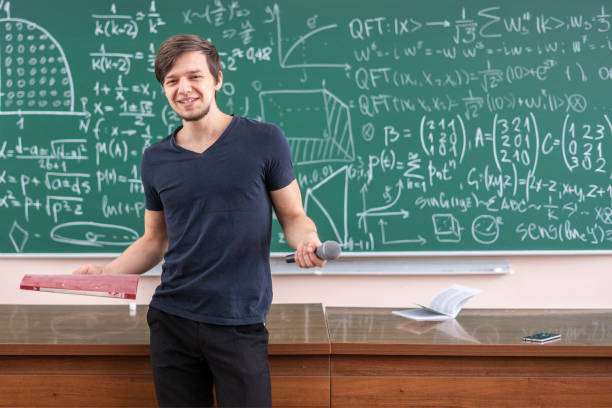 istock happy student portrait in front of blackboard b 1128397406