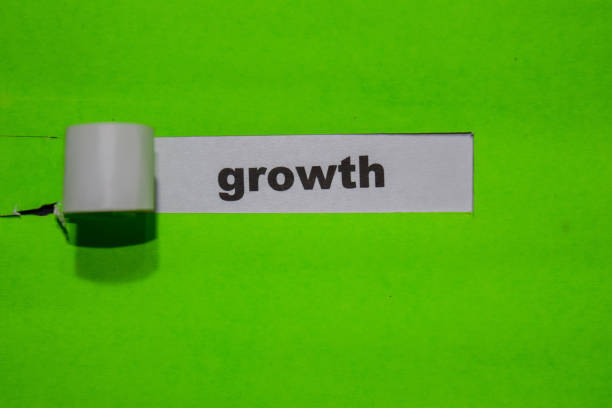 istock Growth, Inspiration and business concept on green torn paper 1128397555