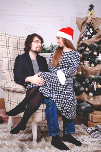 istock Nice couple getting ready for christmas night celebration at home 1128397586
