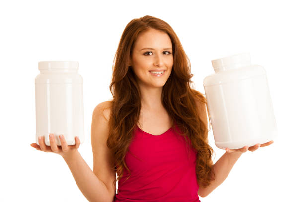 istock Attractive beautiful sporty woman holds blank plastic protein container 1128397693