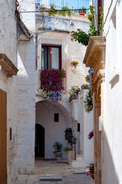 istock Beautiful street in whitewashed town Locorotondo, Apulia 1128403700