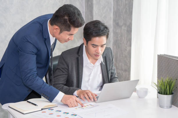 istock Businessman group looking at laptop for discussion about strategy. Brainstorming, Concept for Work, Meeting, Presentation, Coaching. 1128403944