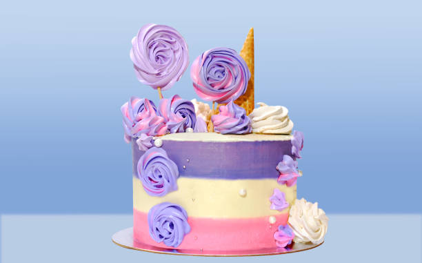 istock festive cake with colored stripes of pink and purple decorated with multicolored marshmallows on a blue background for decoration of holidays and birthdays 1128408021