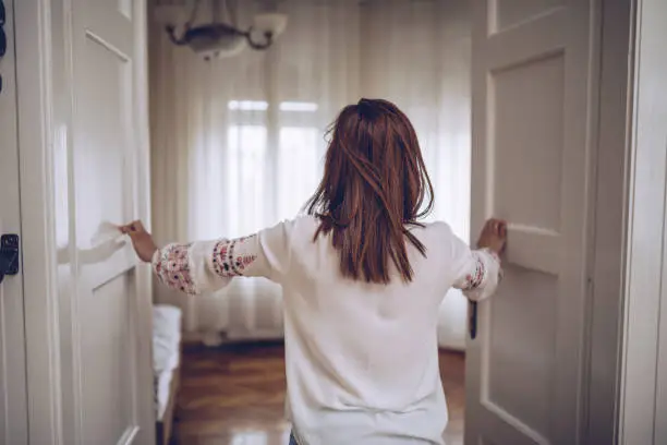 Photo of Woman entering bedroom