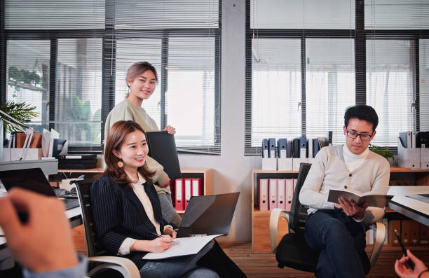 istock businesswomen working in the office. Positive workplace concept 1128415754