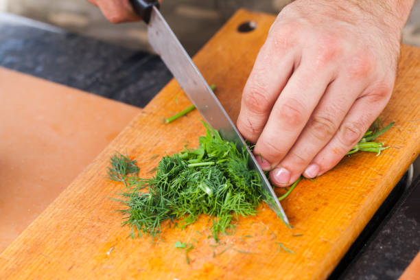 istock Greens chopping. Male hand with knife 1128419152