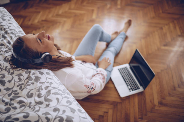 istock Lady relaxing with music in bedroom 1128422988