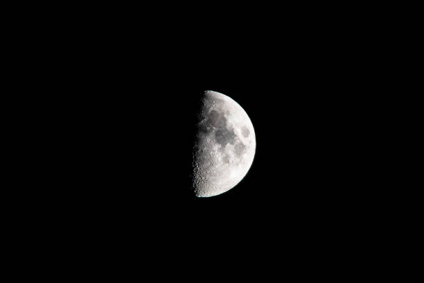 istock Half-Moon Real Picture of Moon on dark night cloudless sky 1128424053