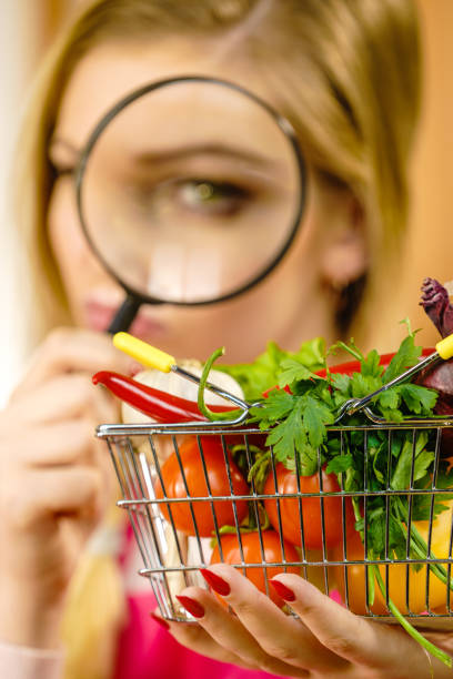 istock Woman investigating shopping backet with vegetables 1128427304