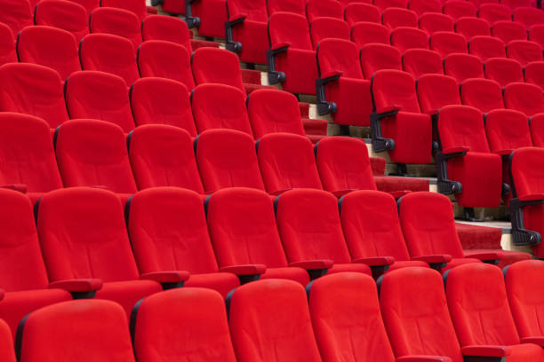 istock pattern of red theater chairs, auditorium 1128427554