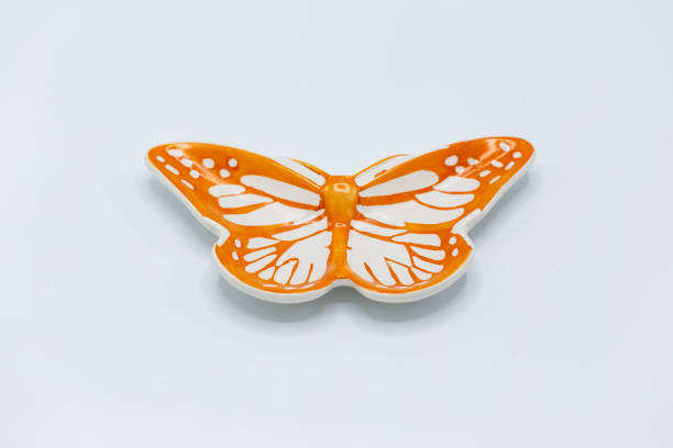 istock small orange and white butterfly shaped ceramic plate 1128433780