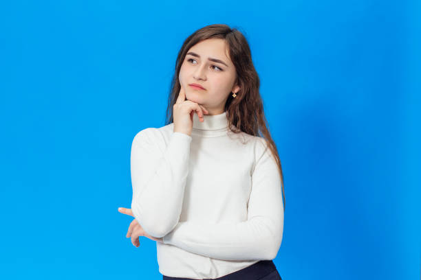 istock Young beautiful girl isolated on blue background 1128436287
