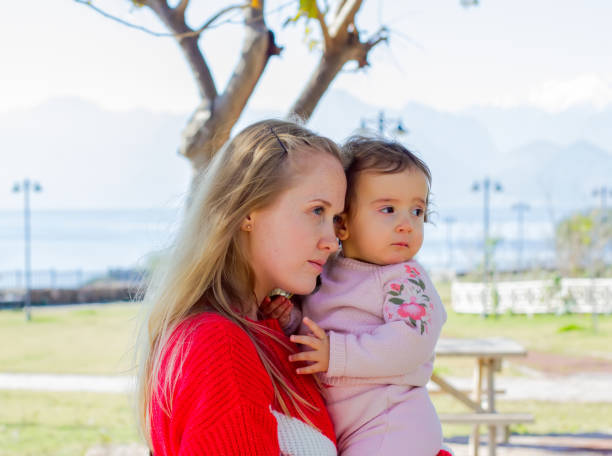 istock Young mother with her daughter for a walk 1128437288