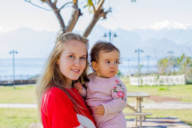 istock Young mother with her daughter for a walk 1128437299