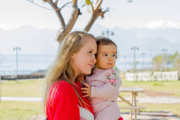 istock Young mother with her daughter for a walk 1128437306