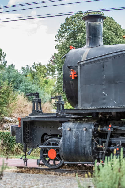 An antique steam train wheels on the track with steam Pretoria South Africa