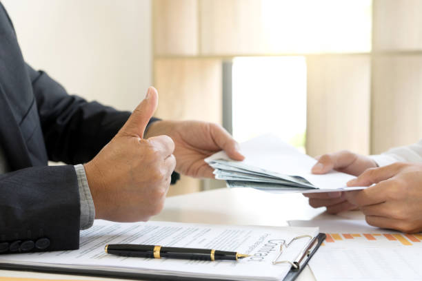 istock Business man give bribe to the officer 1128438039