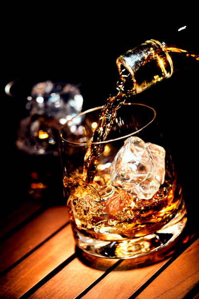 istock Pouring a glass of whiskey on ice 1128440663