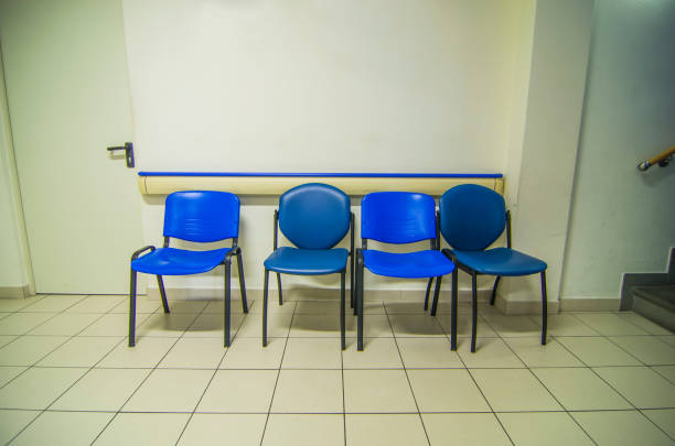 istock empty waiting room with blue metal and plastic chairs 1128441776