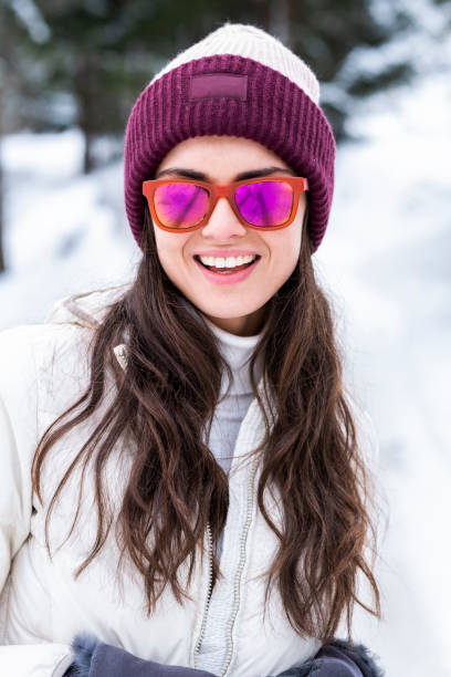 istock Beautiful woman is playing with snow. 1128441931