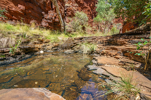 hiking down in the deep and narrow weano gorge in karijini national park, western australia