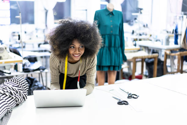 istock Young afro woman in sewing workshop 1128443459