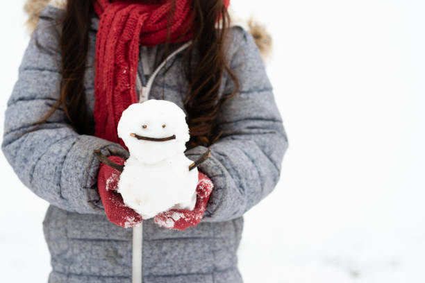 istock Girl playing in the snowy park 1128444170