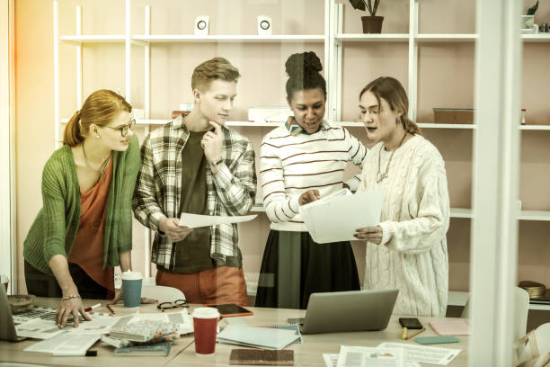 istock African-American teacher helping her students with their project 1128444361