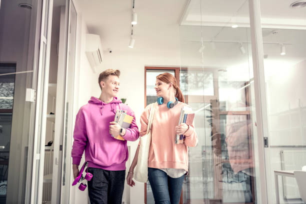 istock Red-haired student looking at her handsome blonde boyfriend 1128444397