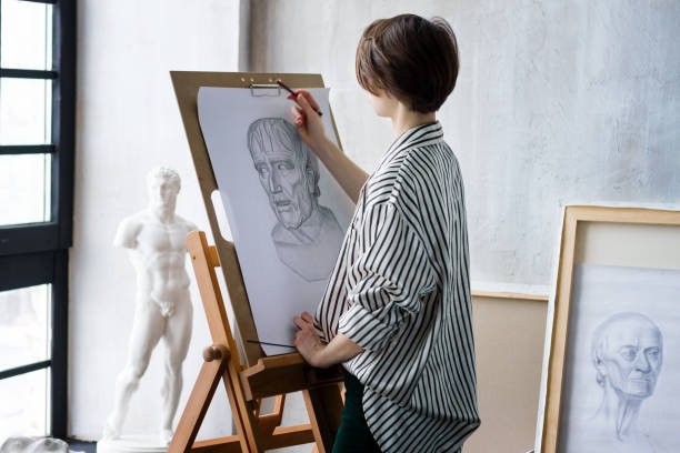 istock Young successful artist in art workshop studio 1128444660