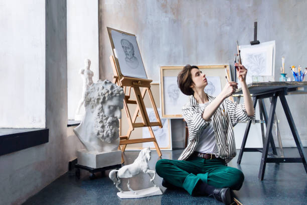 istock Young successful artist in art workshop studio 1128444725