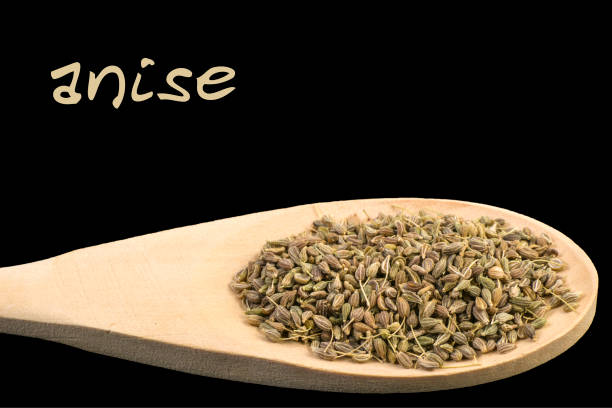 istock anise on wooden spoon isolated on black background 1128444758
