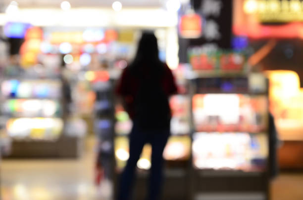 istock Customer picking products in front of  shelves 1128446744