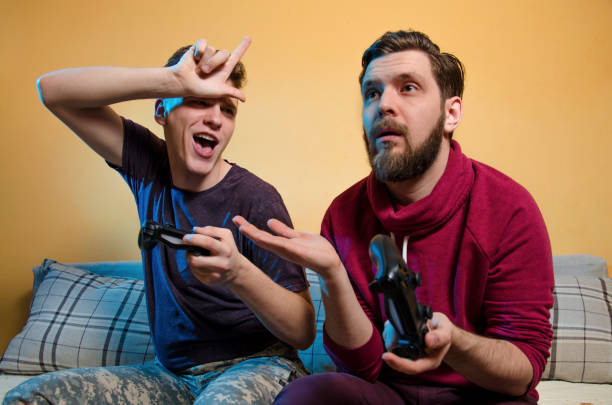 istock Kid teasing older brother, because he won the game 1128447071