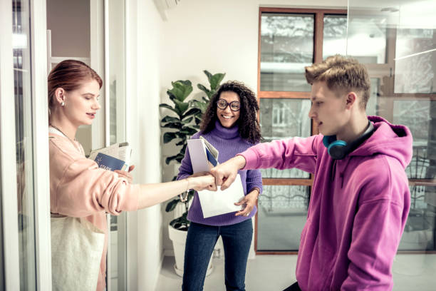 istock Students touching their fists having special friendly gesture 1128448665
