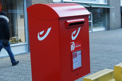 Brussels, Belgium - December 24, 2018: Red Bpost mailbox, outdoors. Bpost, also known as the Belgian Post Group, is the Belgian company responsible for the delivery of national and international mail