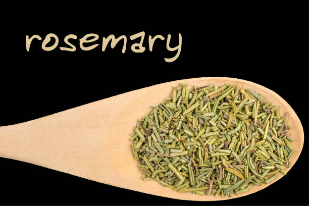 istock rosemary on wooden spoon isolated on black background 1128458220