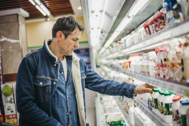 istock Senior man checking products in supermarket 1128459659