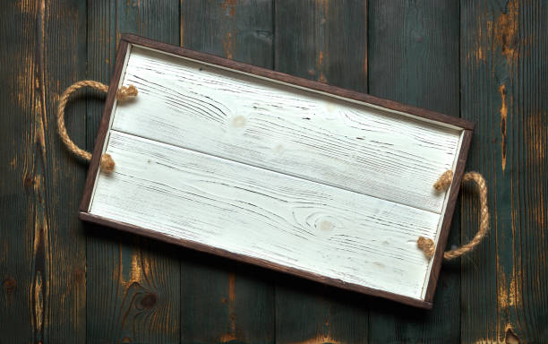 istock Empty white wooden tray on the old green boards. Empty blank for text. 1128461538